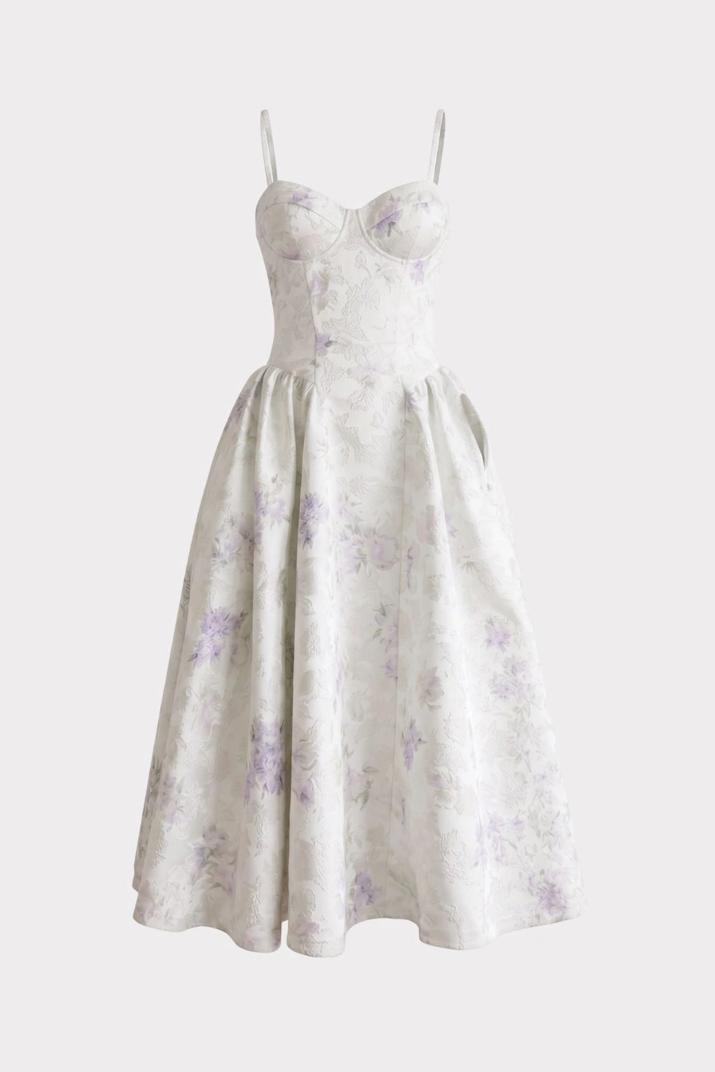 White sleeveless dress with thin straps, sweetheart neckline, fitted bodice, and full skirt with purple floral pattern.