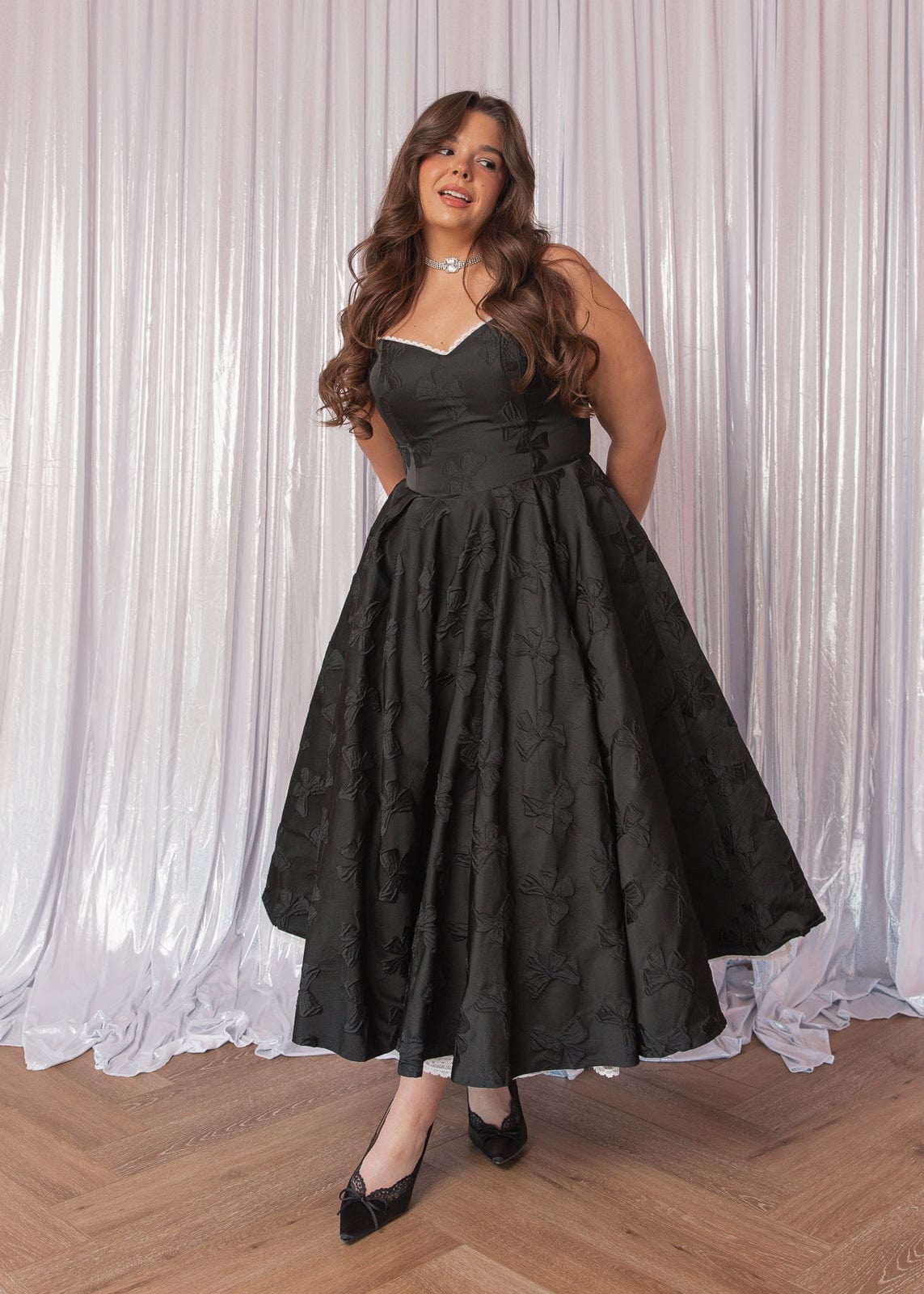 chic size inclusive model wearing JessaKae Kelly Midi Formal Dress - Black