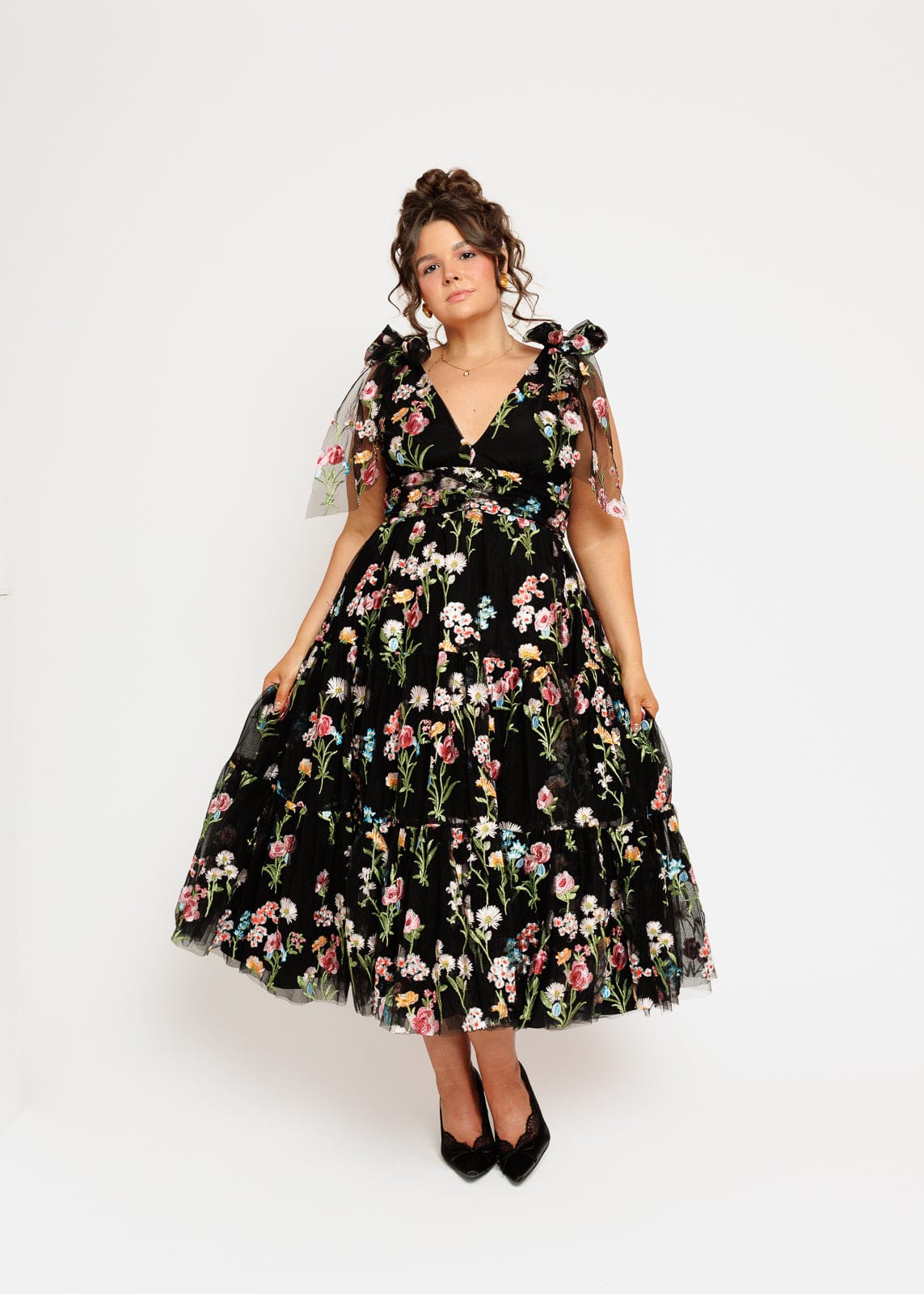 chic size inclusive model wearing JessaKae Margaret Floral Embroidered Midi Dress Black Dresses