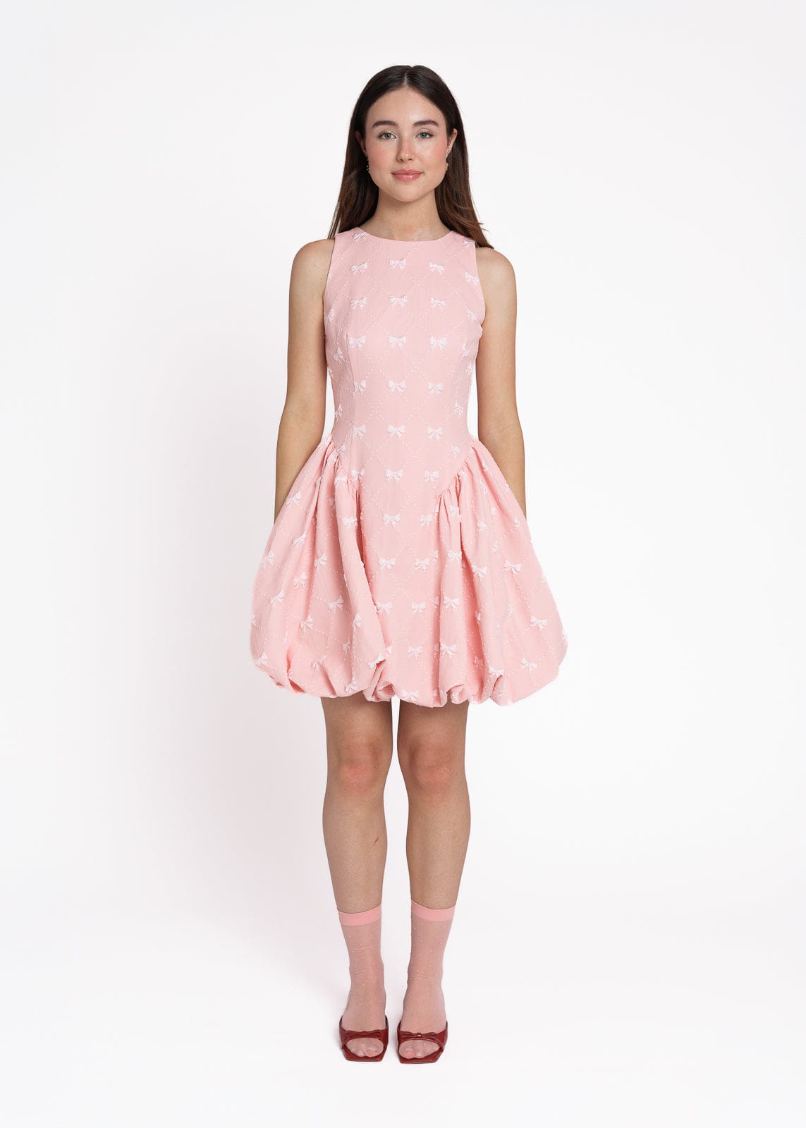 chic size inclusive model wearing JessaKae Scarlett Bubble Hem Mini Dress - Pink