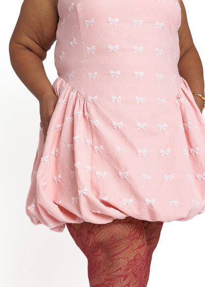 chic size inclusive model wearing JessaKae Scarlett Bubble Hem Mini Dress - Pink