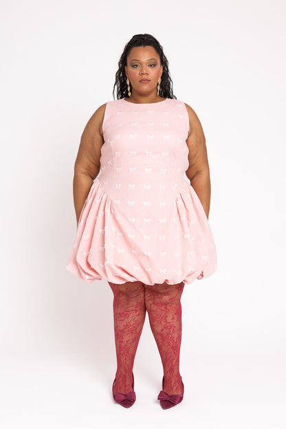 chic size inclusive model wearing JessaKae Scarlett Bubble Hem Mini Dress - Pink