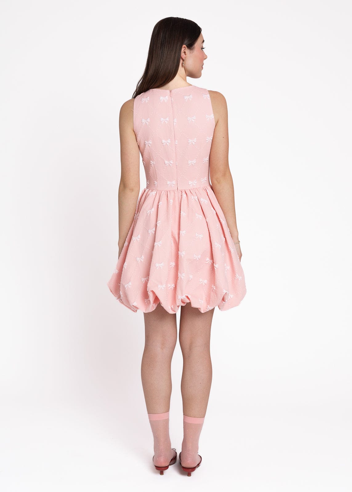 chic size inclusive model wearing JessaKae Scarlett Bubble Hem Mini Dress - Pink