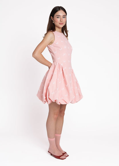 chic size inclusive model wearing JessaKae Scarlett Bubble Hem Mini Dress - Pink