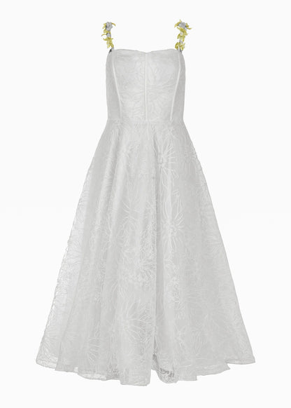 White strapless dress with floral straps and textured fabric, full skirt and fitted bodice, on a plain background.